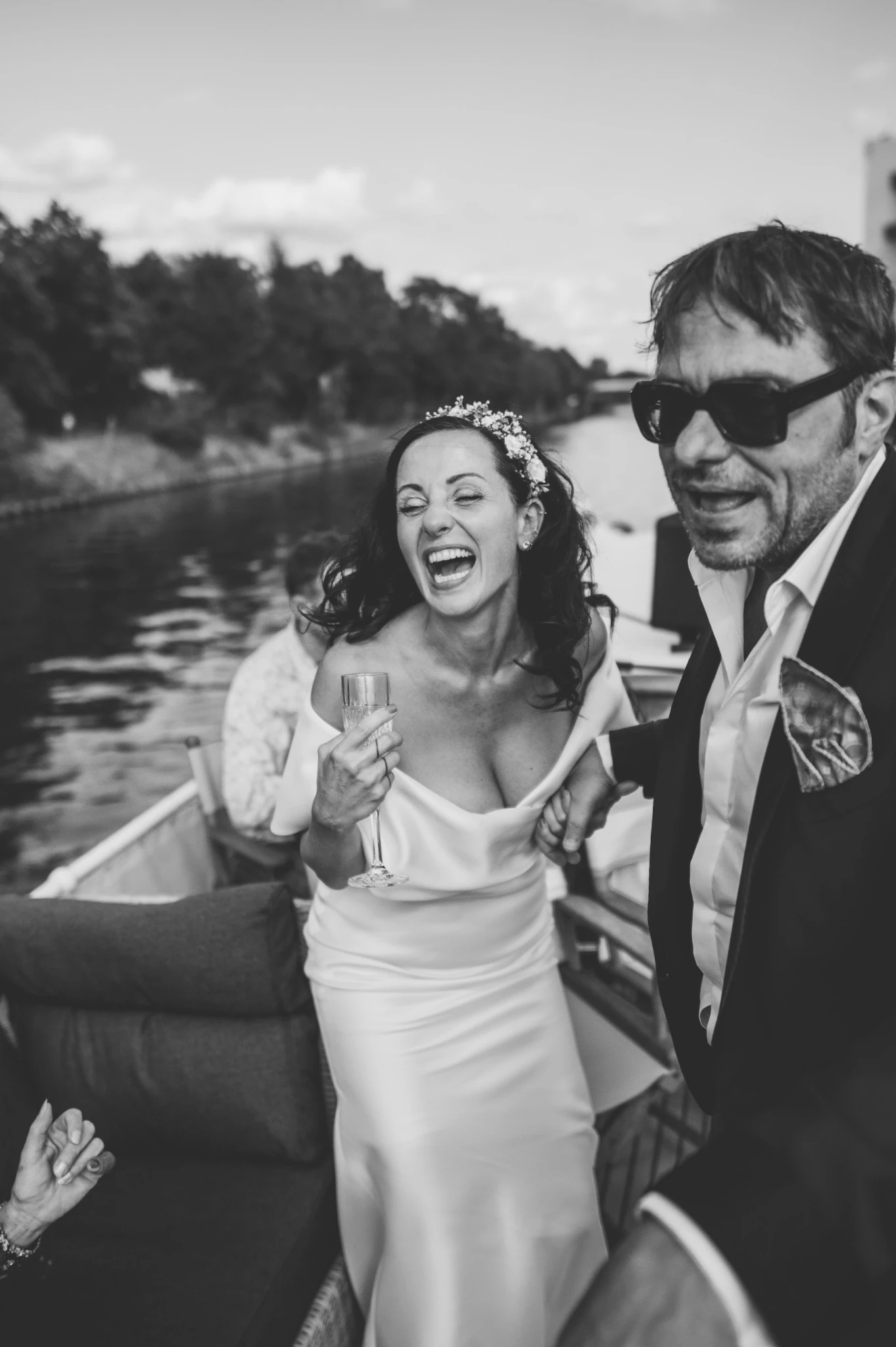 Newlyweds laughing together on a boat