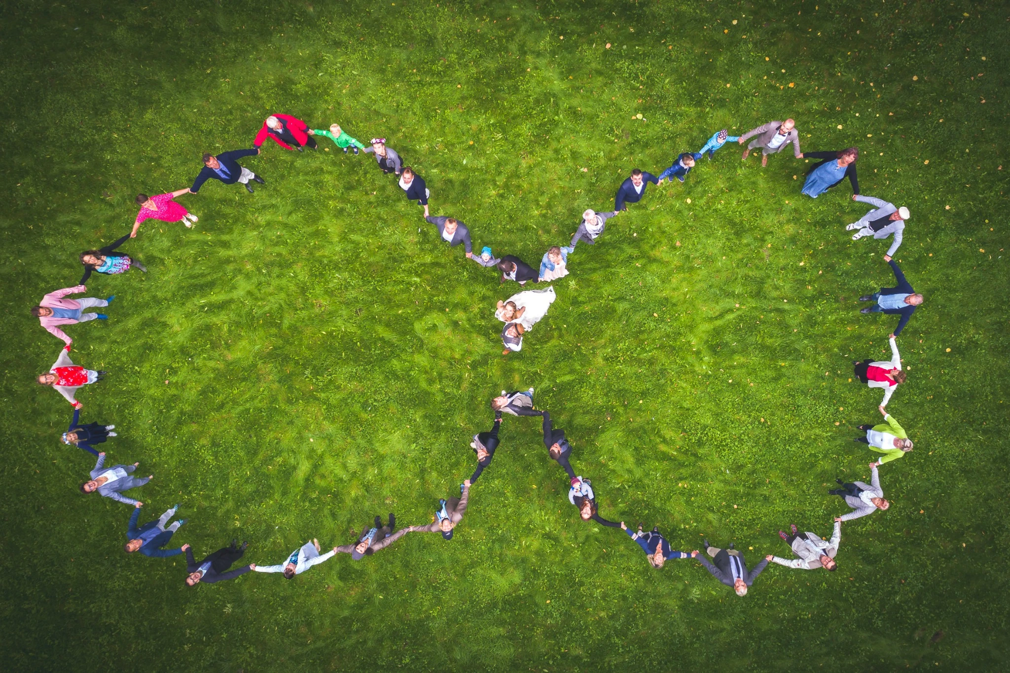 Wedding party forming a heart, photographed from above